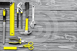 Repair tool kit background. Grey wooden table top view pattern copy space