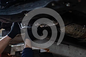 Repair of undercarriage of front suspension of vehicle in garage