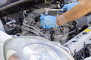 Repair of vehicle engine. Car spark plug and ignition coil change or replacement.
