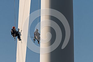 Repair at the wind turbine, climbing, workers