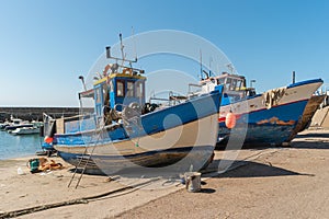 Repair of wooden boats in dry-dock. Boats are raised and waiting for repairs