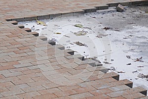 Repair work on city street paving brick with self-locking blocks