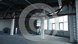 Repair work in empty room with large windows. Stock footage. Renovation in new empty room for company with steel beams