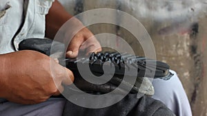 Repairing broken shoes by a shoe repairman