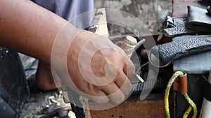 Repairing broken shoes by a shoe repairman