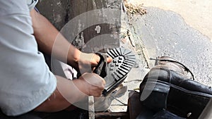 Repairing broken shoes by a shoe repairman