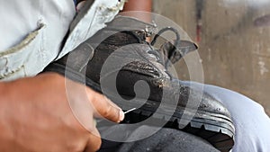 Repairing broken shoes by a shoe repairman