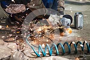 Mechanic cuts new pipe for corrugation muffler photo