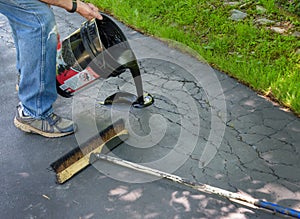 Repairing cracks in driveway with asphalt sealant