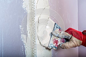Repairing fireplace surface with spackle and trowel by hand