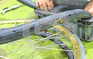 Repairing a flat tire of an bicycle tire. Patched up inner tube