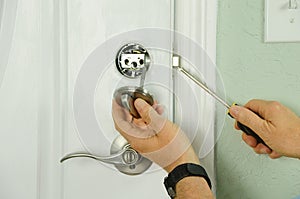 Repairing installing door deadbolt lock on house closeup photo