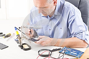 Repairing mobile phone in the electronic workshop