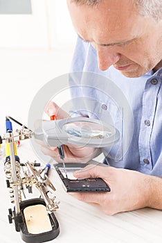 Repairing mobile phone in the electronic workshop
