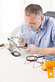 Repairing mobile phone in the electronic workshop