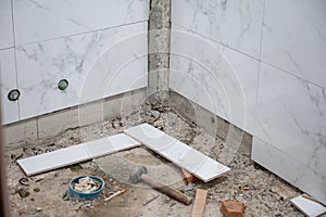 Repairing wall of bathroom with tiling marble tile and tools