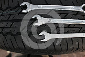 Repairing Wrenches Lying On A New Car Tire Top View