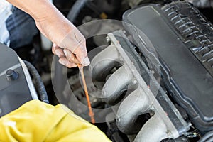 Repairman auto mechanic check engine oil condition. man worker service engine mechanic garage. Transportation repair service