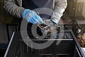 Repairman cleaning computer hardware.