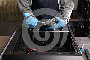 Repairman cleaning computer hardware.