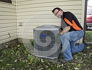 Repairman Cleaning Outside Air Conditioner Unit Grill