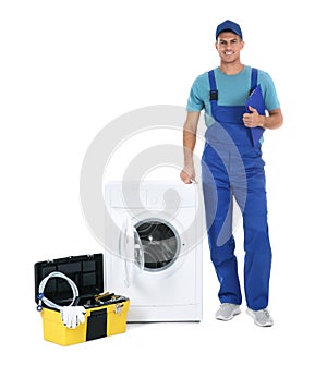 Repairman with clipboard and toolbox near washing machine on background