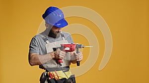 Repairman contractor drilling nails with electric power drill