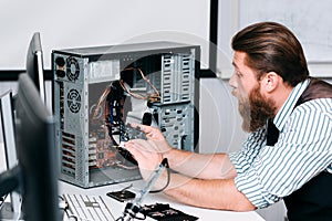 Repairman disassembling computer unit for repair