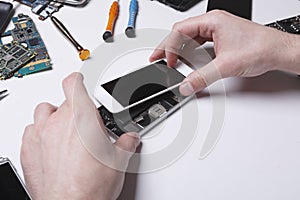 Repairman disassembling phone for inspecting
