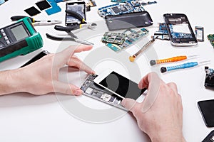 Repairman disassembling phone for inspecting