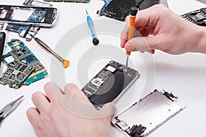 Repairman disassembling phone with screwdriver