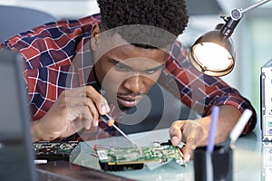 Repairman disassembling smartphone with screwdriver