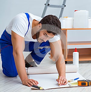 Repairman doing renovation repair in the house with paper wallpa