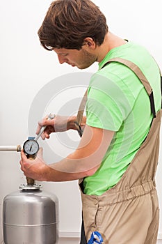 Repairman fixing valves in home