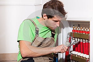 Repairman fixing valves in home