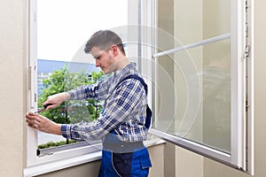 Repairman Fixing Window With Screwdriver