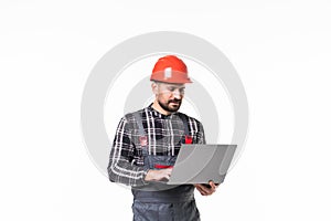 Repairman in hemlet using laptop against white background