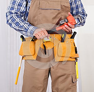 Repairman Holding Adjustable Wrench