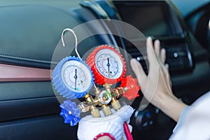 Repairman holding monitor tool to check and fix car air conditioner system, Technician checks car air conditioning system