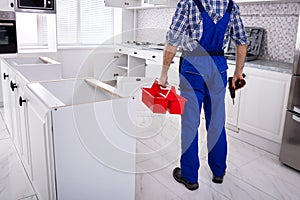 Repairman Holding Tool Box Installing Kitchen