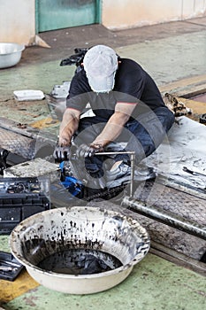 repairman holding a wrench and tighten and during maintenance work of machine