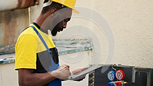 Repairman inspecting refrigerant levels