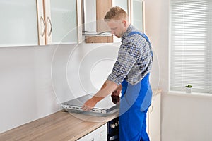 Repairman Installing Induction Cooker