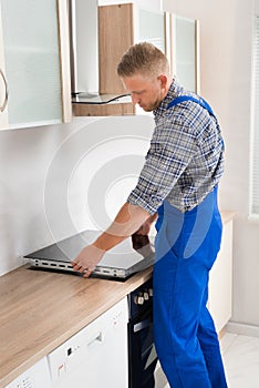 Repairman Installing Induction Cooker