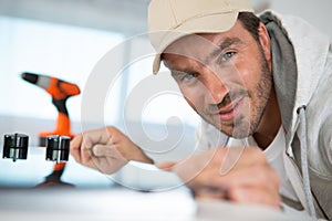 repairman installing induction cooker in kitchen