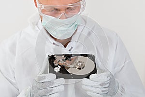 Repairman Looking At Computer Harddisk