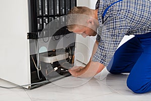 Repairman Making Refrigerator Appliance