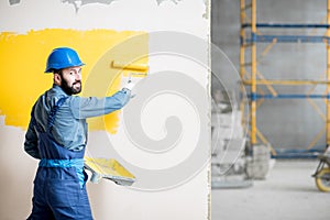 Repairman painting wall