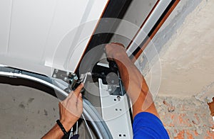 Repairman repair garage door opener. Garage door replacement, garage door repair.