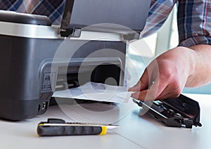 Repairman repairing broken color printer